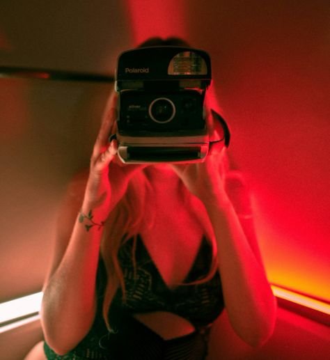 A sexy woman films for one-way sex cams.
